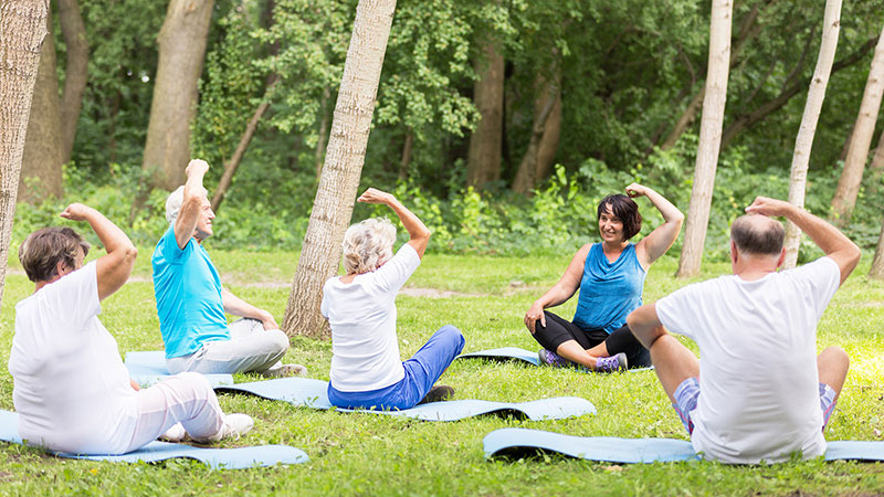 active grandparents excercising in garden