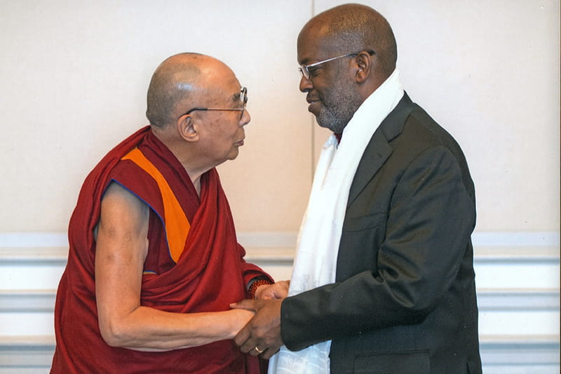 Bernard J Tyson shaking hands with the Dalai Lama