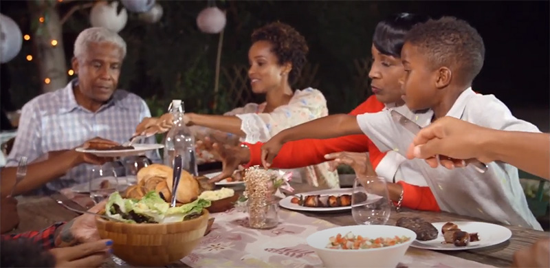 family eating meal outdoors together