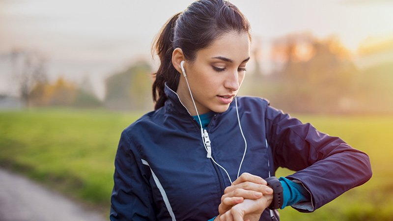 female runner checking watch