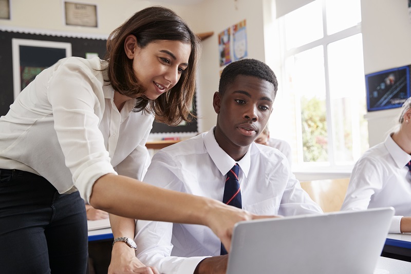 female teacher working with student