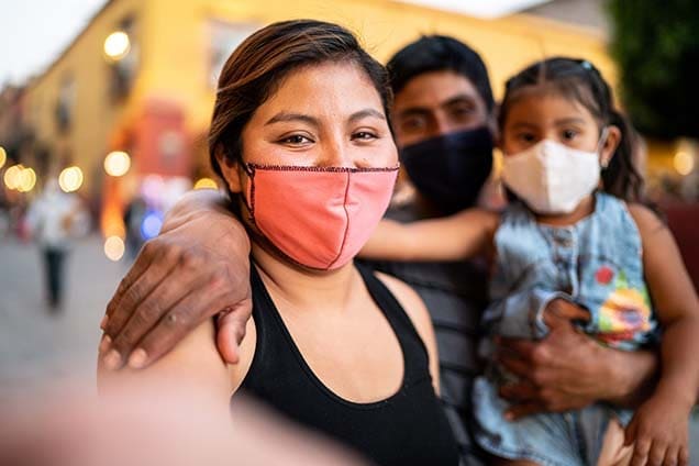 Masked family at outdoor event