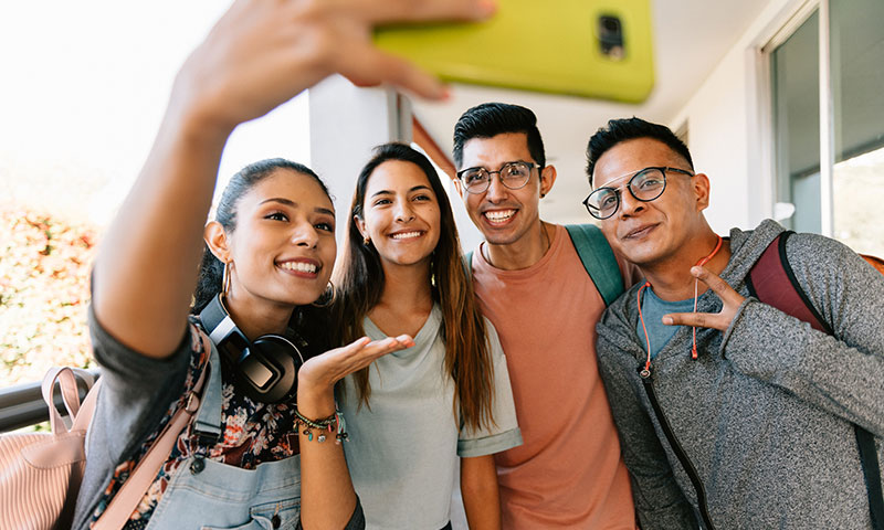 happy college students take a selfie outdoors