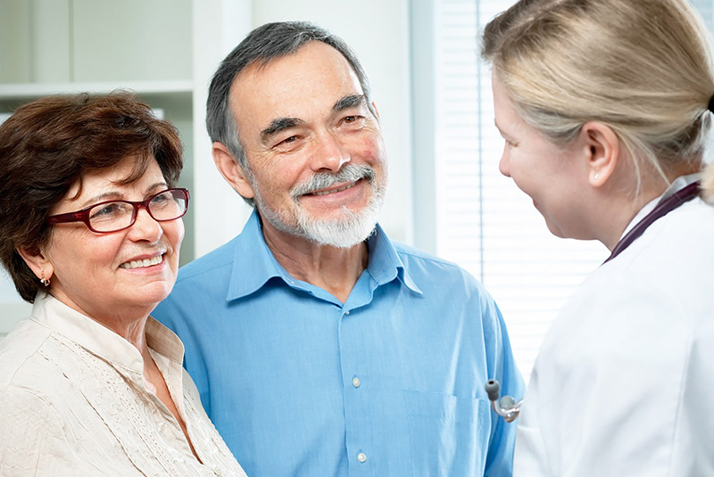 doctor talking with couple