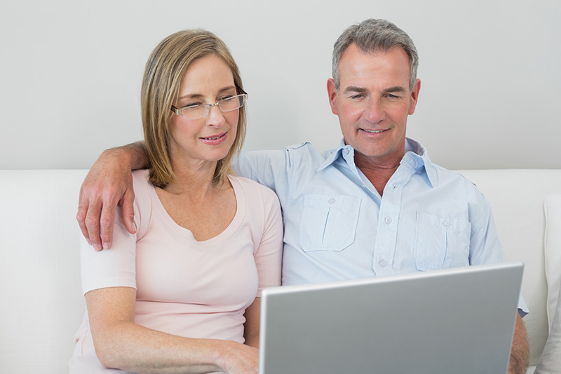 senior couple using laptop