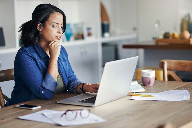 woman researching on laptop