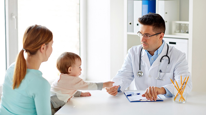 woman with baby and doctor at clinic