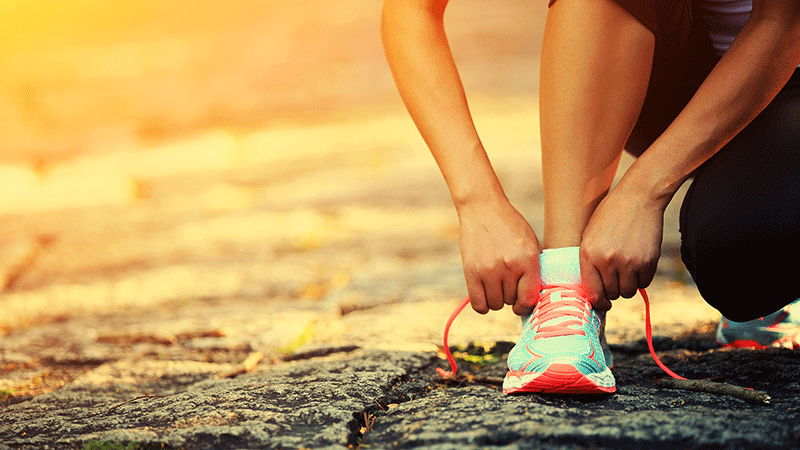 Woman tying shoes